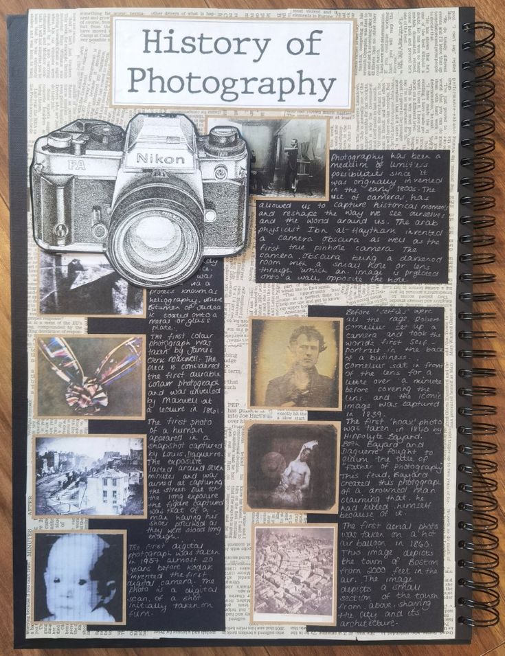 a book with pictures on it sitting on top of a wooden table next to a camera