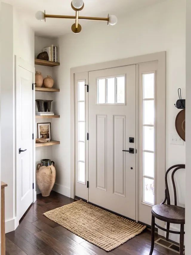 a white door and some shelves in a room