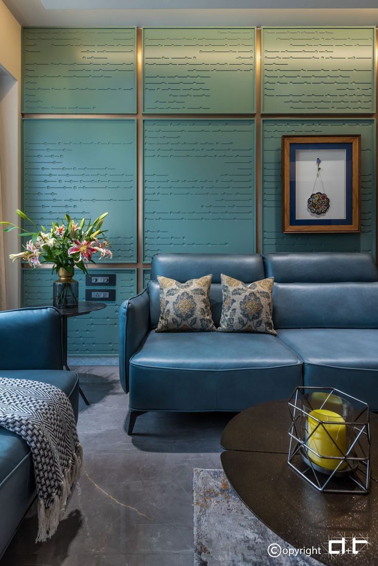 a blue couch sitting next to a table in a living room