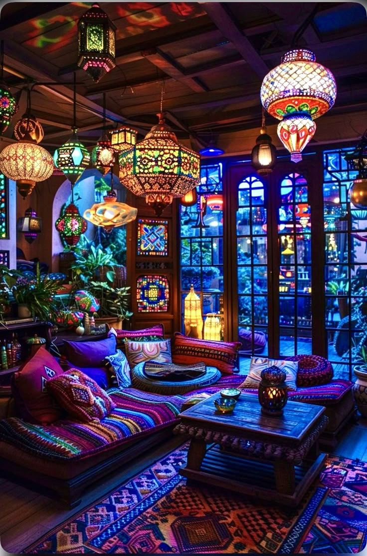 a living room filled with lots of furniture and colorful lights hanging from the ceiling above