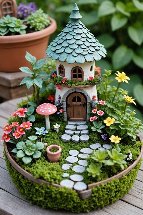 a miniature garden with flowers, plants and a small house in the middle of it