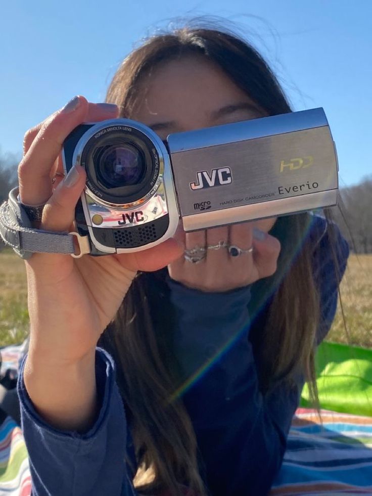 a woman holding up a camera in front of her face