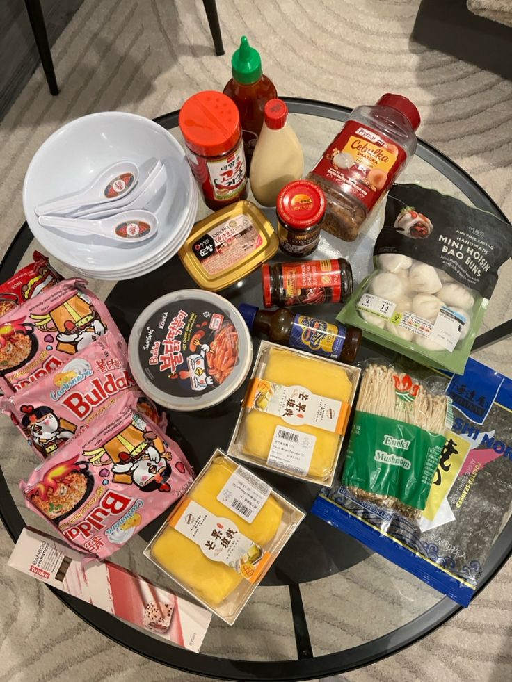 an assortment of food items sitting on top of a glass table