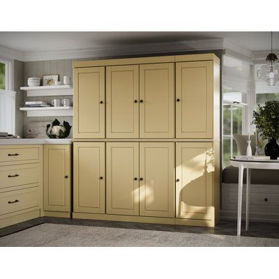 an image of a kitchen setting with yellow cabinets