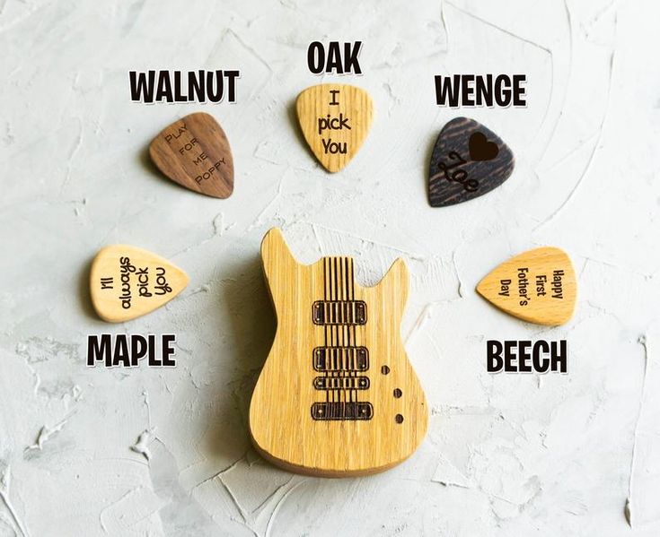 wooden guitar picks with words written on them that spell out the names of their guitars