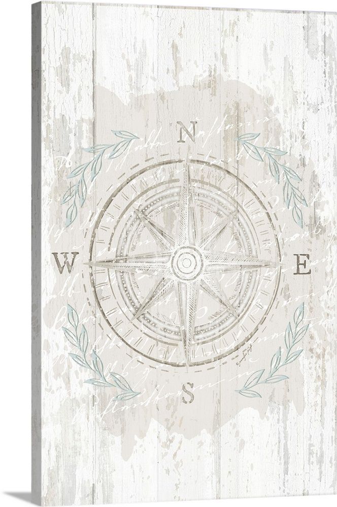 an old compass with leaves on it and the word w e is written in blue ink