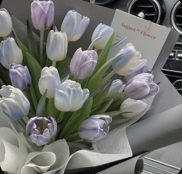 a bouquet of tulips sitting in the center of a car