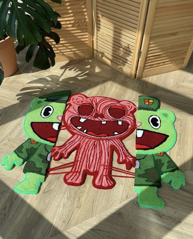 two green and red rugs with cartoon characters on the floor next to each other