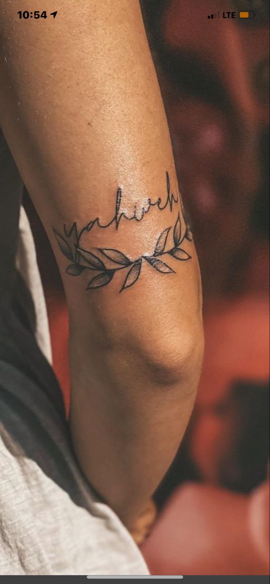 a woman's arm with a tattoo that says faith on the left side of her arm