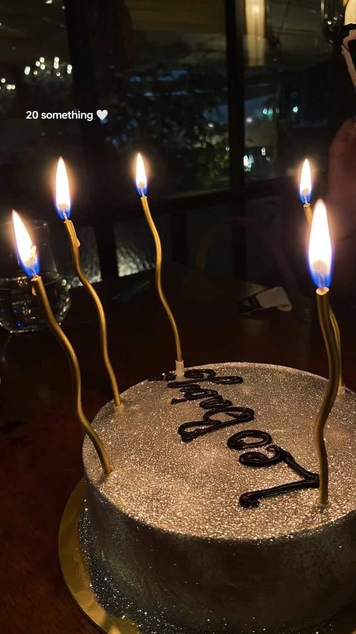 a birthday cake with lit candles on it