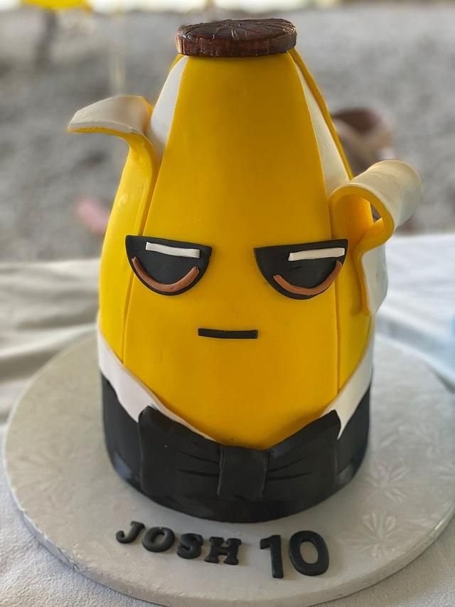 a close up of a cake with a banana on it's face and eyes