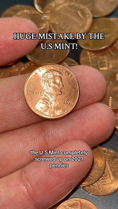 a hand holding a coin with the words, huge money by the u s mint