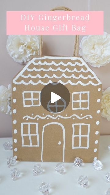 a gingerbread house gift bag is shown with flowers in the background and text overlay that reads diy gingerbread house gift bag