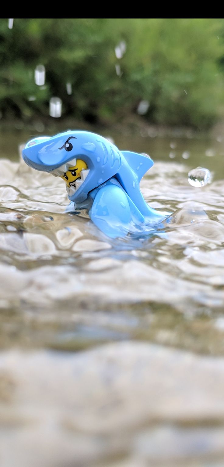 a toy elephant is floating in the water