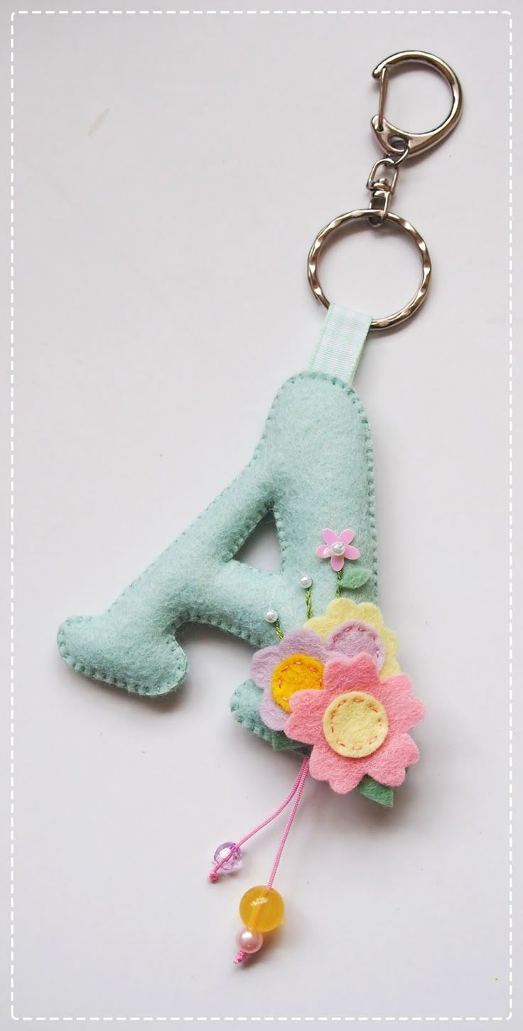 a keychain with a flower on it and the number four attached to it