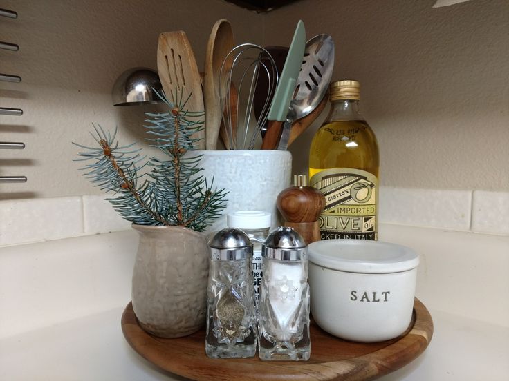 various kitchen utensils are arranged on a wooden tray