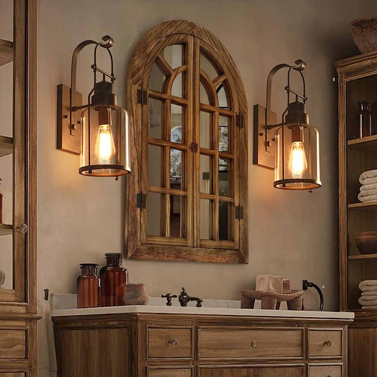 a bathroom with wooden cabinets and two hanging lights