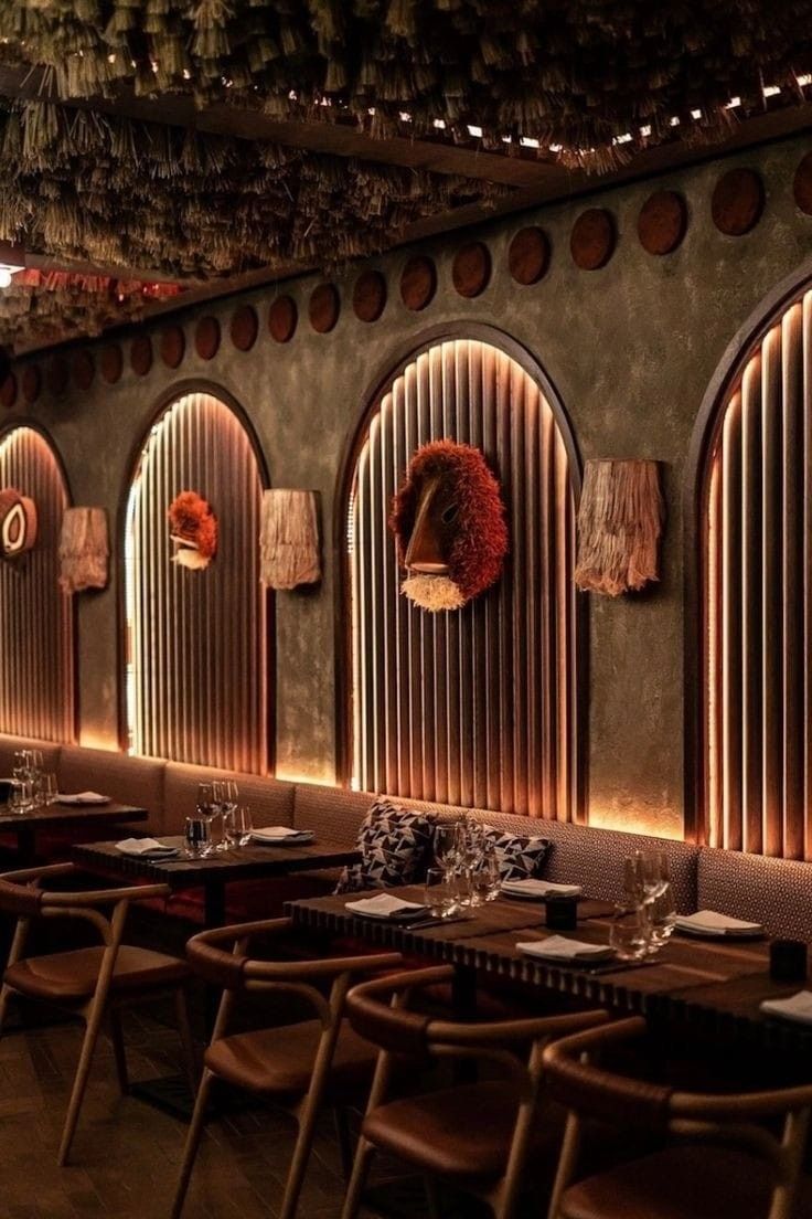 a restaurant with tables and chairs lined up against the wall, along with hanging decorations