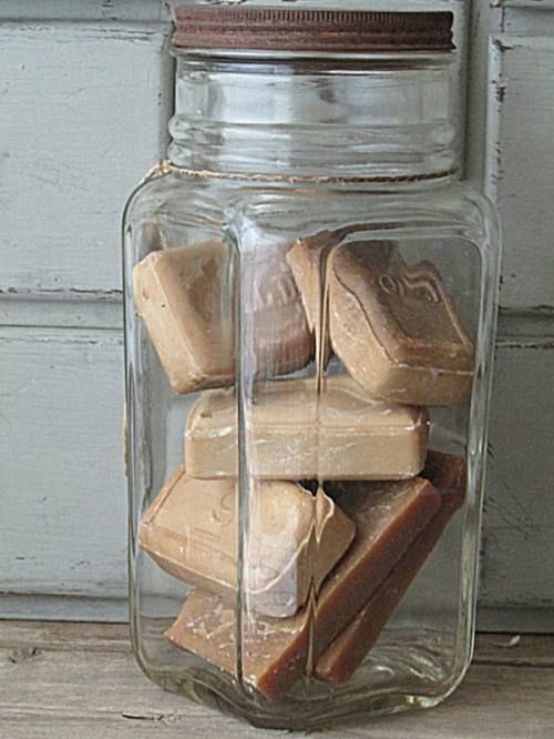 a glass jar filled with lots of wooden blocks