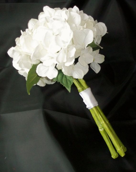 a bouquet of white flowers on a black background