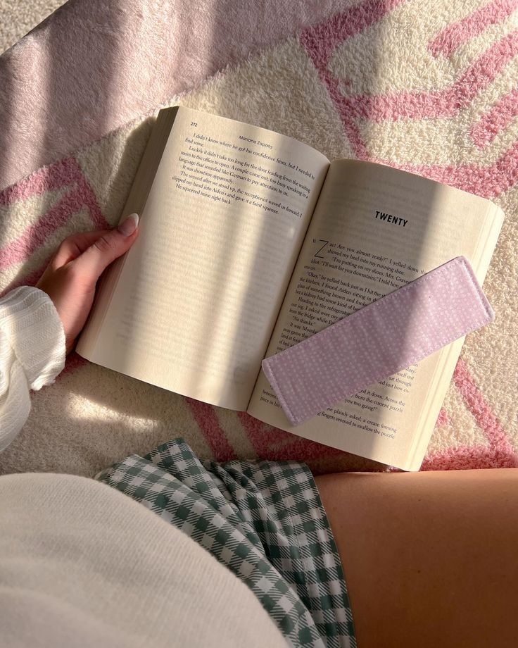 a person laying on the floor reading a book