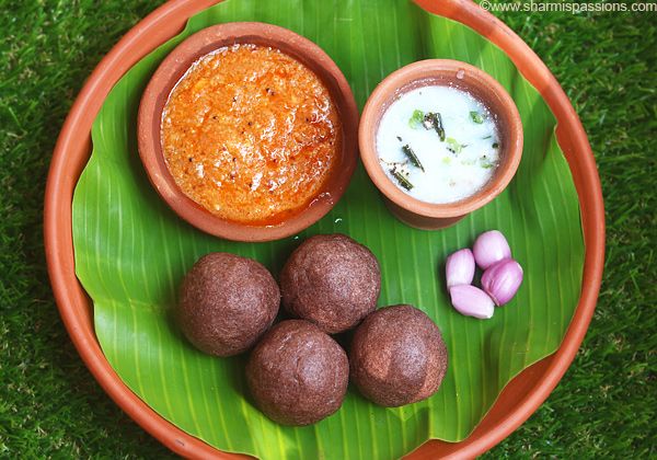 a plate with some food on it sitting in the grass next to two bowls and three small candies