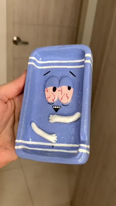 someone is holding up a blue spongebob dish