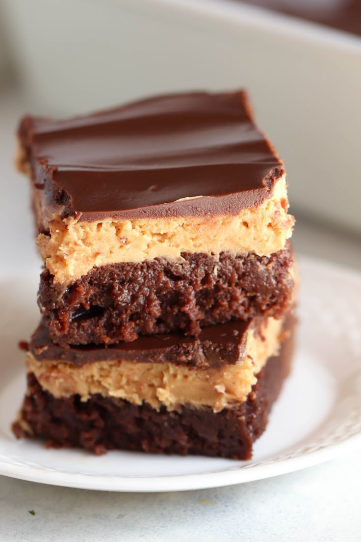 three pieces of cake sitting on top of a white plate