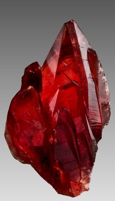 a red rock with large crystals on it