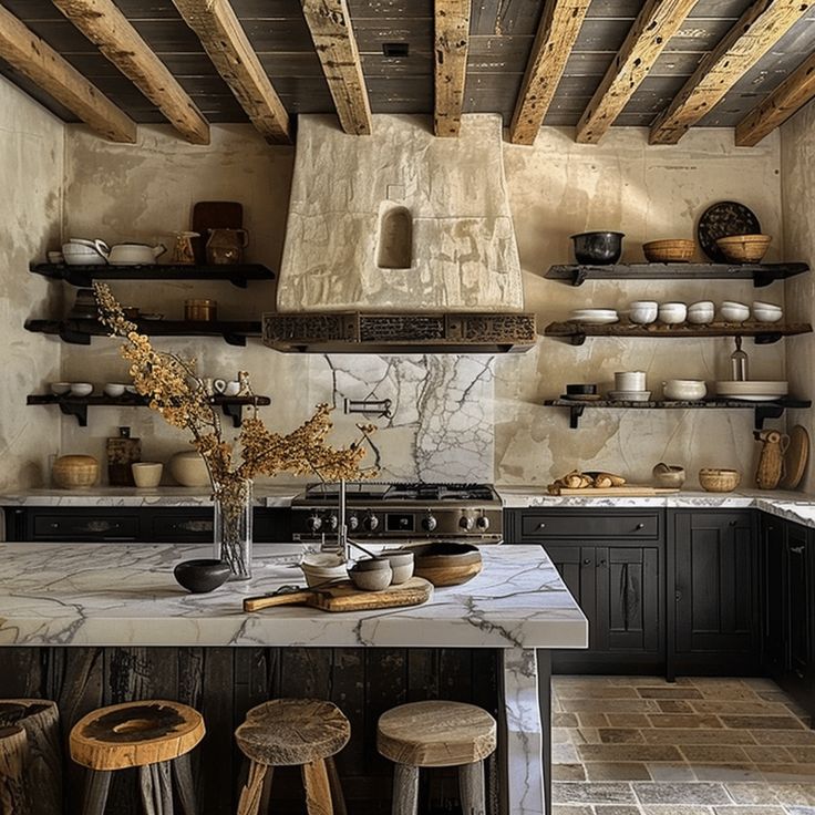 a kitchen with black cabinets and white marble counter tops, wooden beams in the ceiling