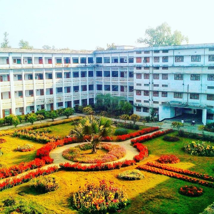 an aerial view of a building with flowers in the foreground