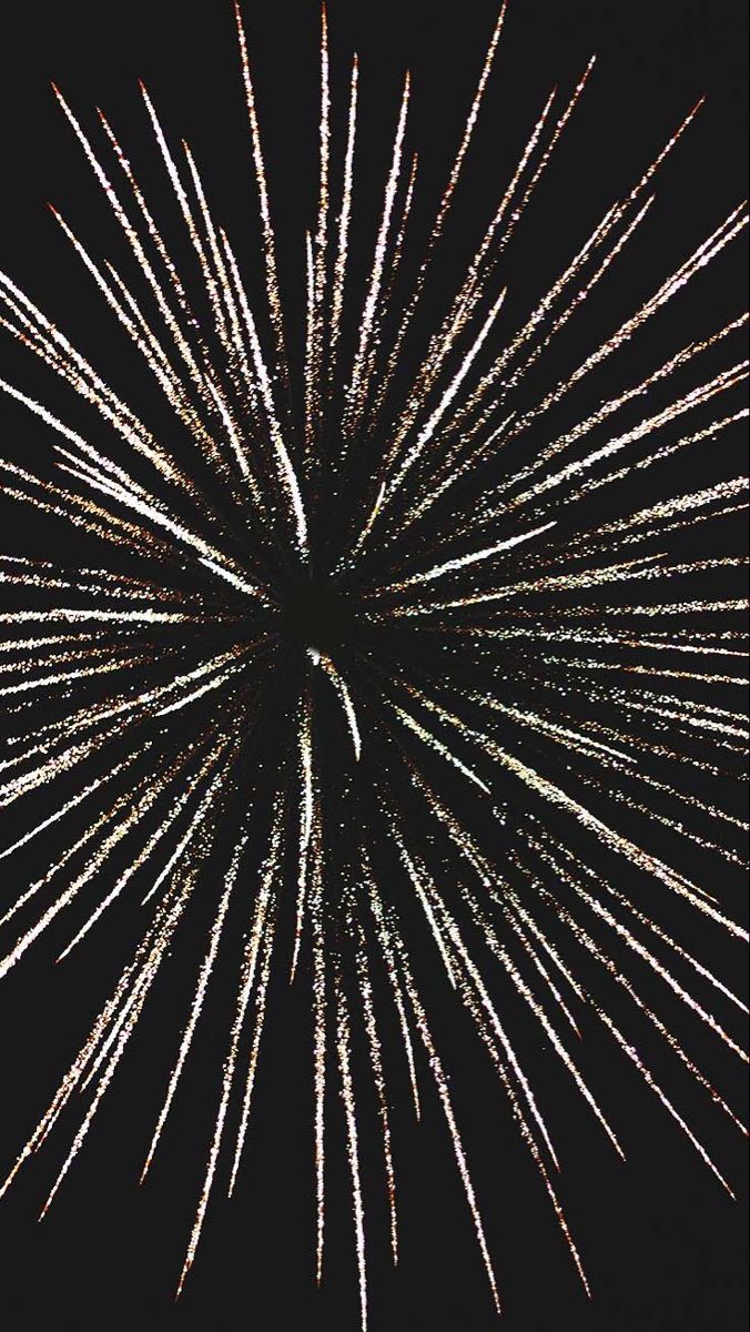 a black and white photo of fireworks in the night sky with no people around it