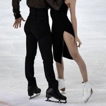 a man and woman skating on an ice rink