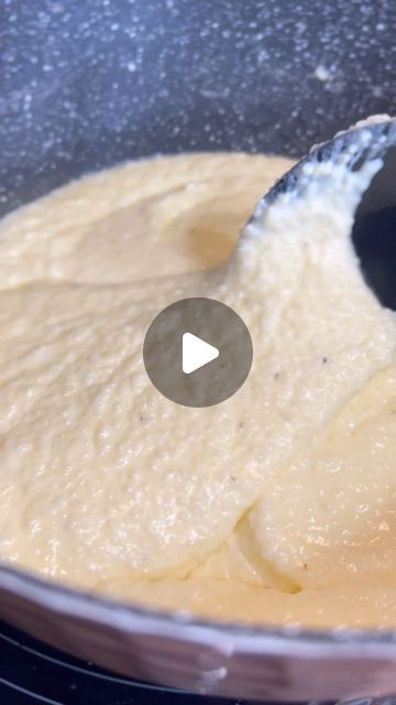 a pan filled with batter being stirred by a spoon