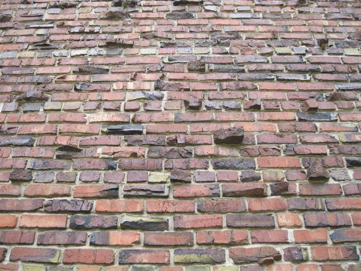 an old brick wall that has been made from bricks and is missing the top part