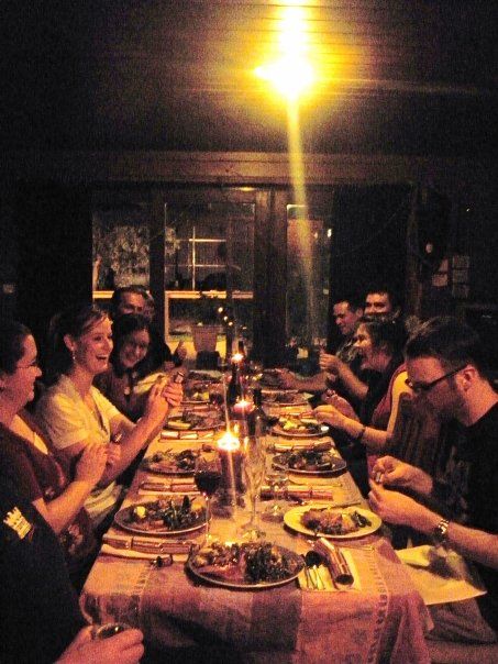 a group of people sitting around a dinner table