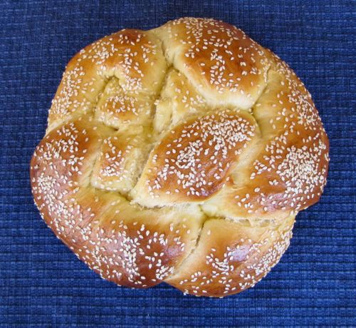 a close up of a bread with sesame seeds on the top and in the middle