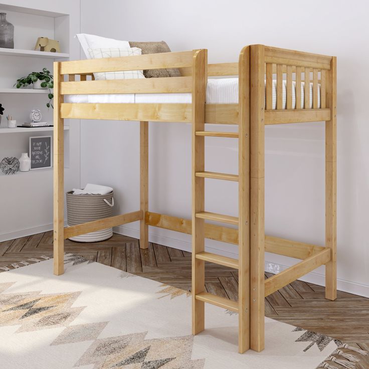 a wooden bunk bed sitting on top of a hard wood floor next to a white wall