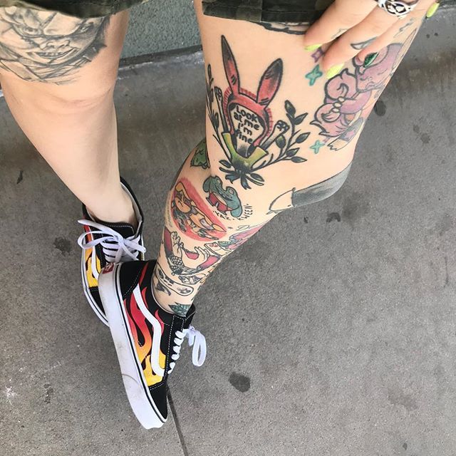 a person with tattoos on their legs and shoes