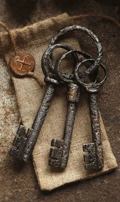 two old keys are sitting on a piece of cloth