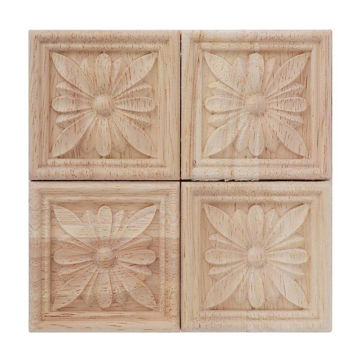 four square wooden plaques with flower designs on them