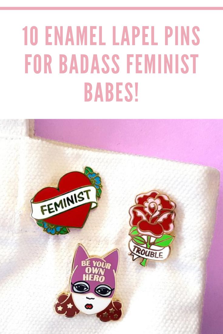 two pin badges with the words feminist on them and an image of a cat holding a heart