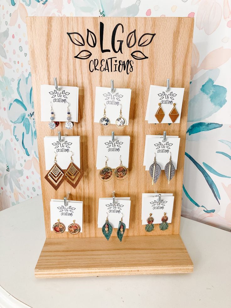 a wooden display with earrings on it