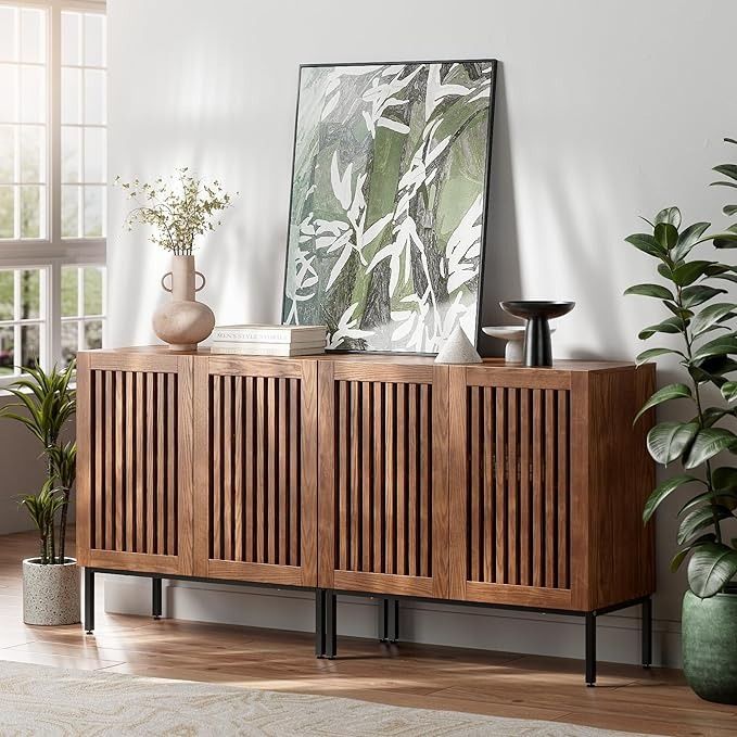 a wooden cabinet sitting in the corner of a room with plants and vases on it