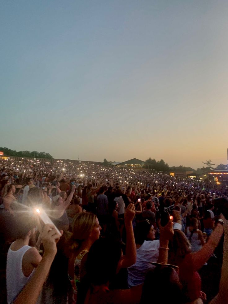 a large group of people standing around each other