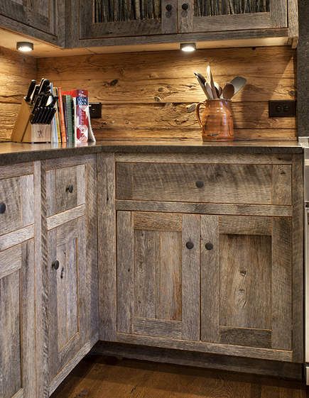 a kitchen with wooden cabinets and wood flooring, along with lights on the ceiling