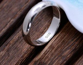 a wedding ring sitting on top of a wooden table