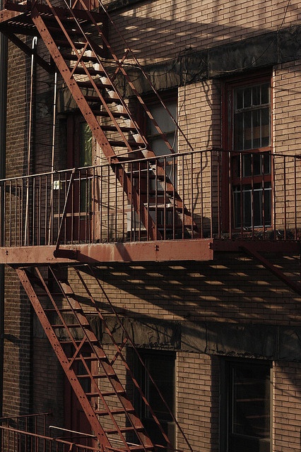 a fire escape on the side of an old brick building