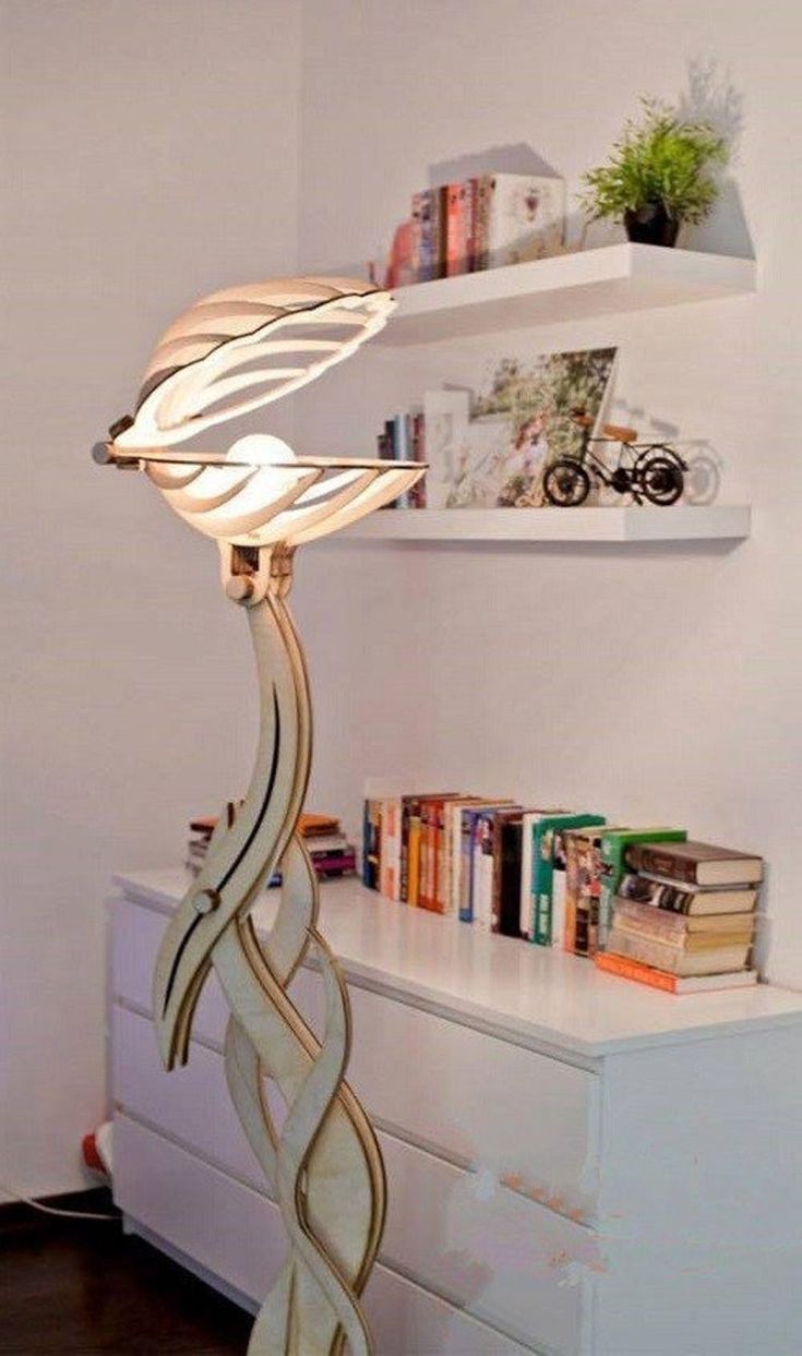 a lamp sitting on top of a white dresser next to a book shelf filled with books