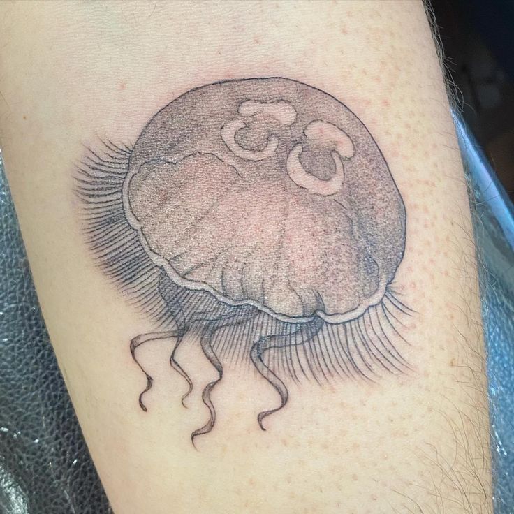 a black and white photo of a jellyfish tattoo